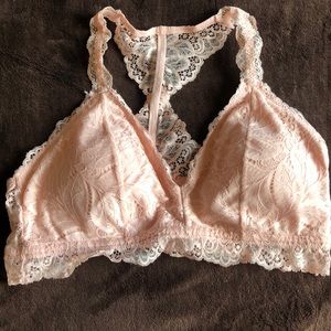 A lightly lined, baby pink bralette.